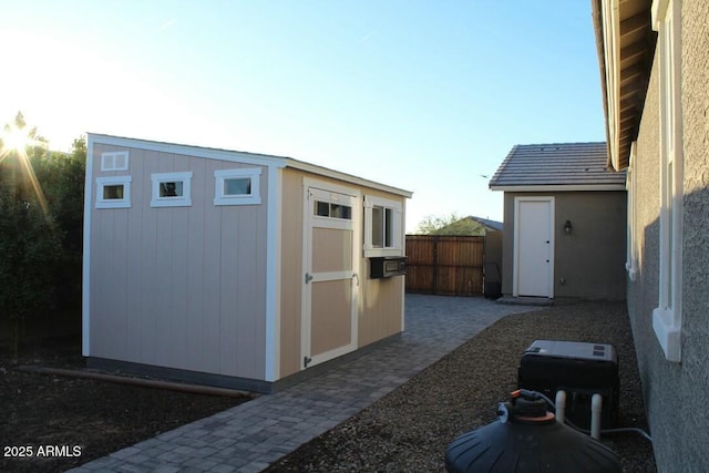 view of shed with fence