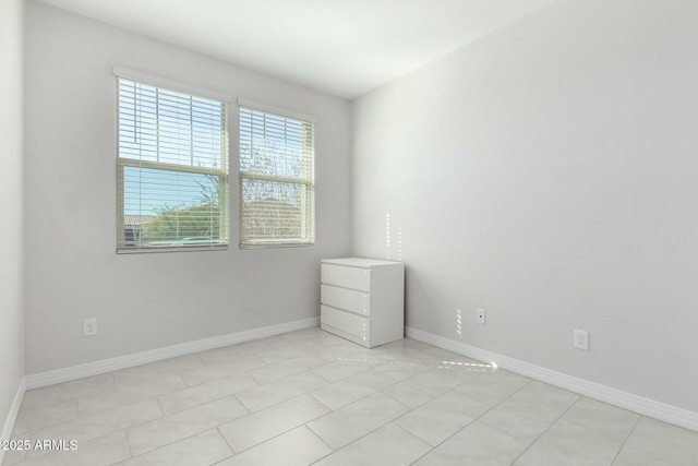 unfurnished room featuring baseboards