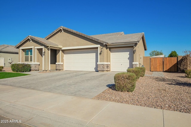 view of front of house with a garage, stone siding, a tile roof, decorative driveway, and stucco siding