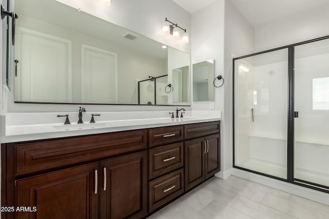 full bathroom featuring visible vents, a sink, a shower stall, and double vanity