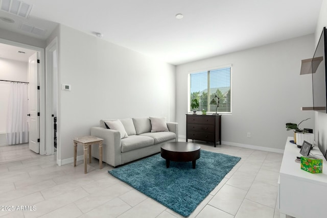 living room featuring baseboards and visible vents