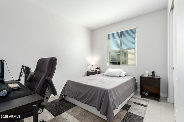 bedroom with baseboards and light tile patterned flooring