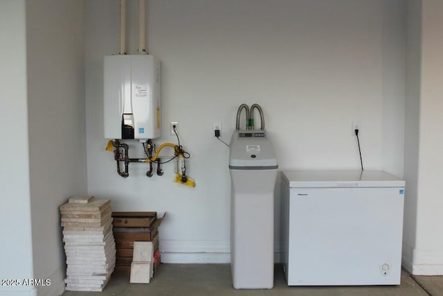 laundry room featuring tankless water heater