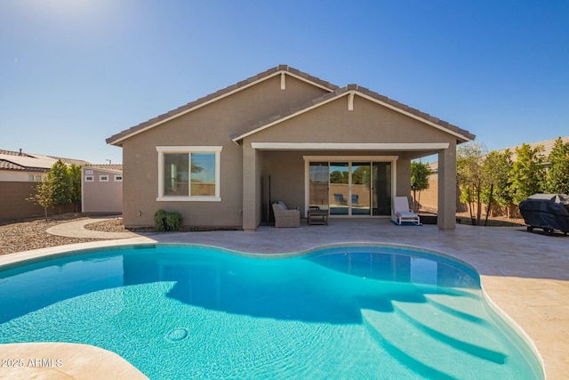 exterior space featuring a fenced in pool and a patio