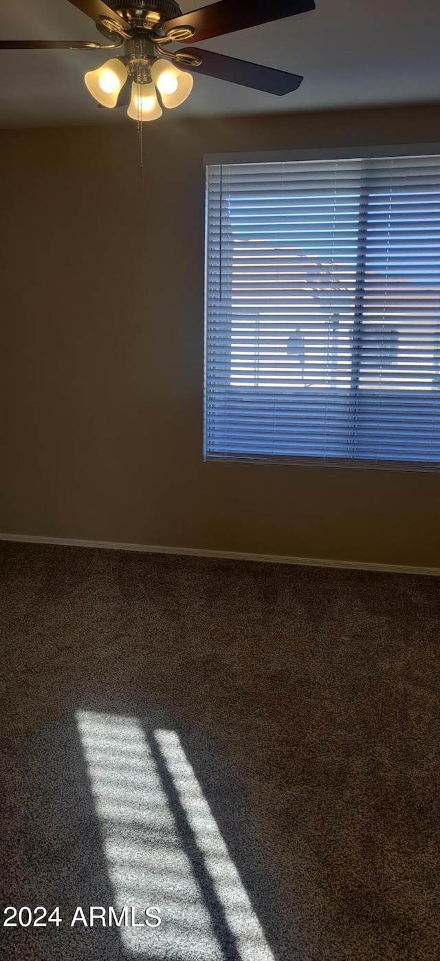 empty room with carpet floors and ceiling fan