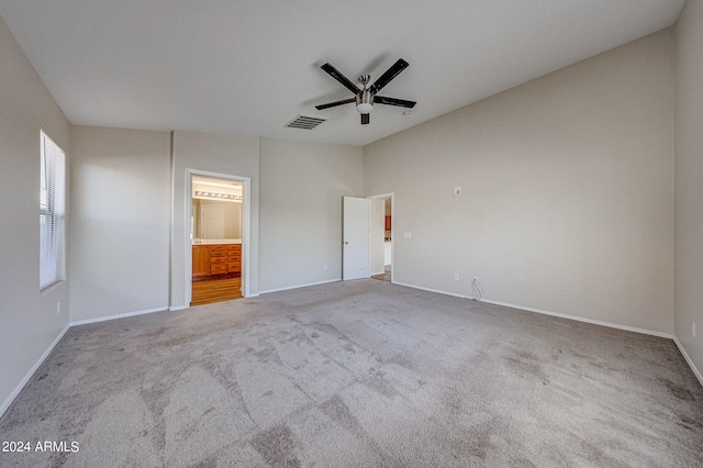 unfurnished bedroom with ensuite bathroom, carpet, and ceiling fan