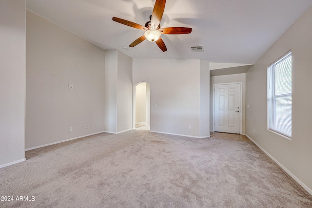 carpeted empty room featuring ceiling fan and vaulted ceiling