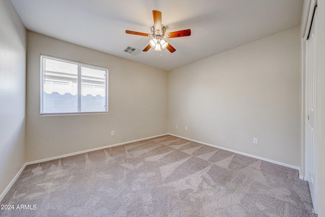 unfurnished room featuring ceiling fan and light carpet