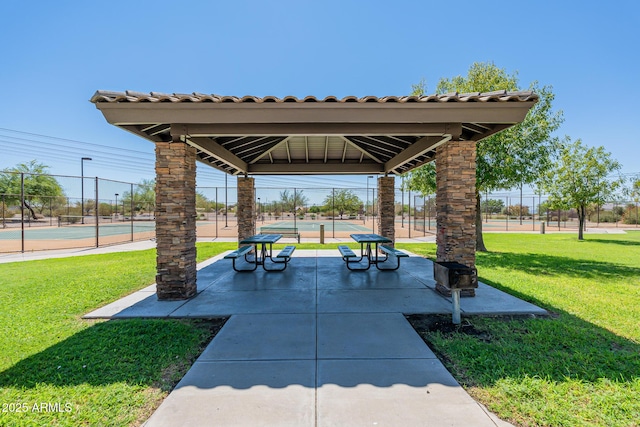 surrounding community featuring a gazebo, a lawn, and tennis court