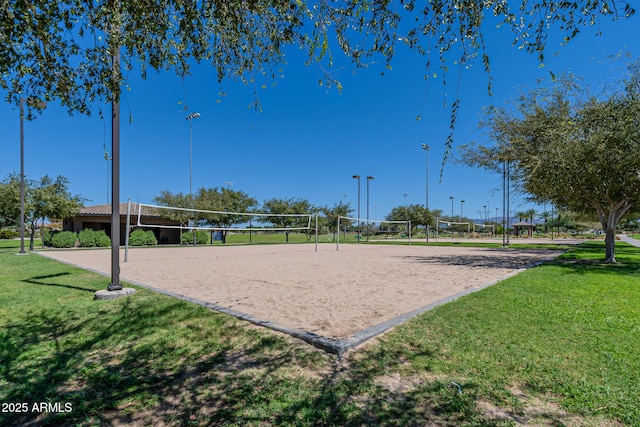 view of home's community featuring a yard and volleyball court