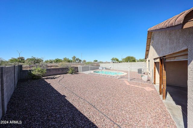 view of yard featuring a fenced in pool and a patio