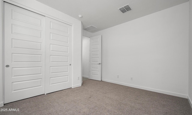 unfurnished bedroom featuring carpet floors and a closet