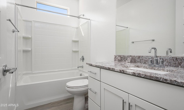 full bathroom with hardwood / wood-style floors, vanity, bathing tub / shower combination, and toilet