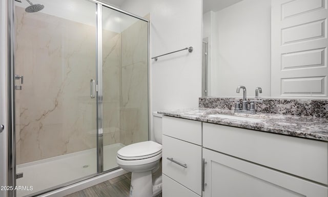 bathroom with vanity, toilet, and walk in shower