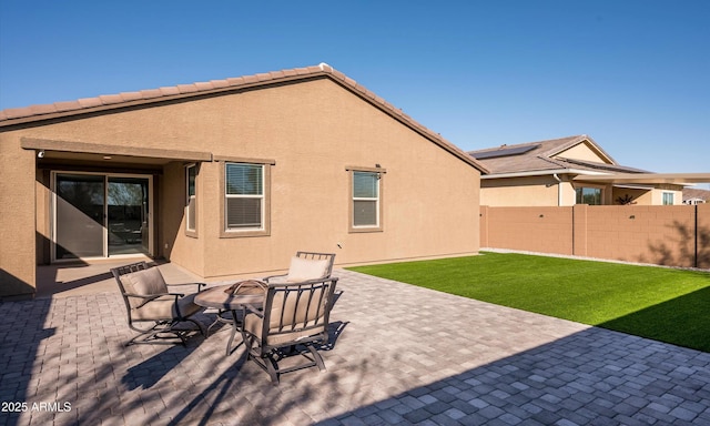 back of house with a yard and a patio area