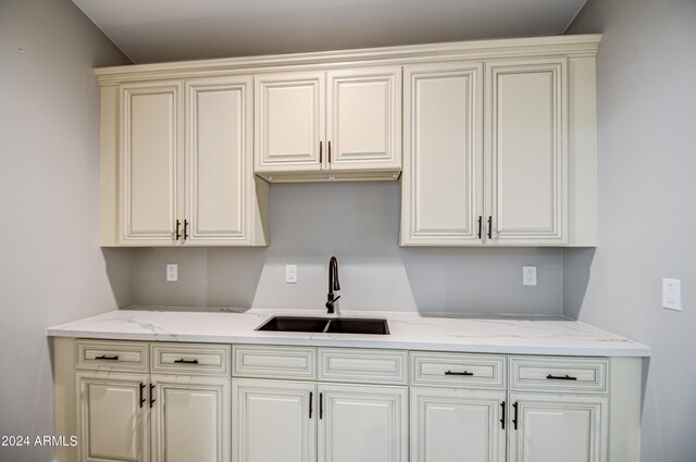 kitchen with light stone countertops and sink