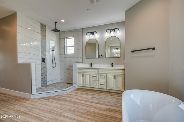 bathroom featuring dual vanity and plus walk in shower