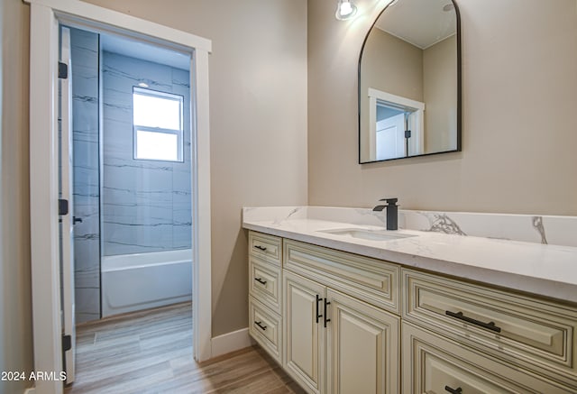 bathroom with tiled shower / bath and vanity