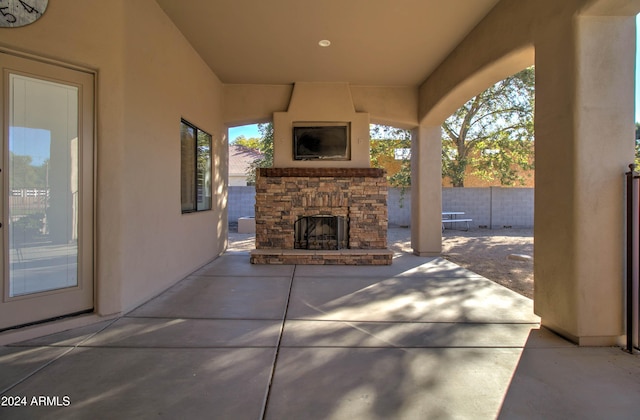 view of patio featuring an outdoor stone fireplace