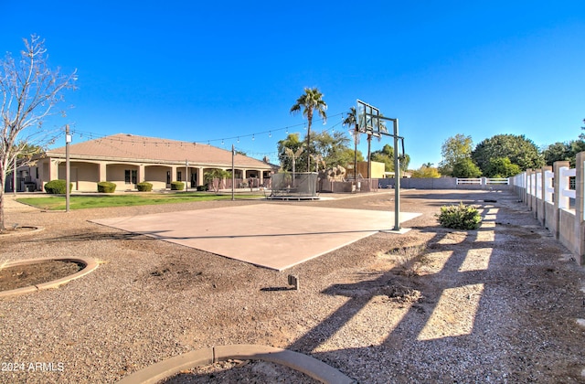 view of basketball court with a trampoline