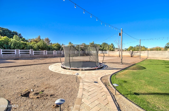 view of playground featuring a yard and a trampoline