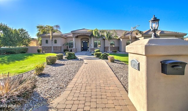 mediterranean / spanish-style home featuring a front lawn