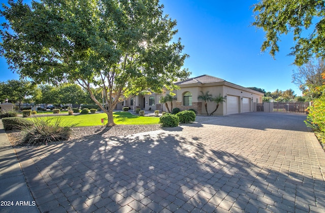 view of front of property featuring a front lawn and a garage