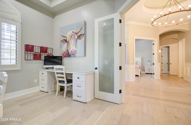 office space with an inviting chandelier, light hardwood / wood-style flooring, and ornamental molding