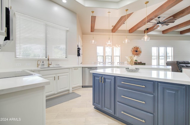 kitchen with white cabinetry, plenty of natural light, stainless steel dishwasher, and blue cabinetry