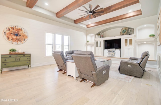 living room featuring beamed ceiling and light wood-type flooring