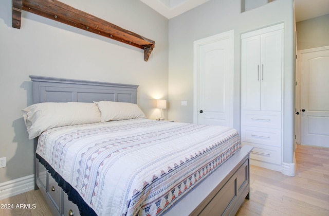 bedroom featuring light hardwood / wood-style floors and a closet