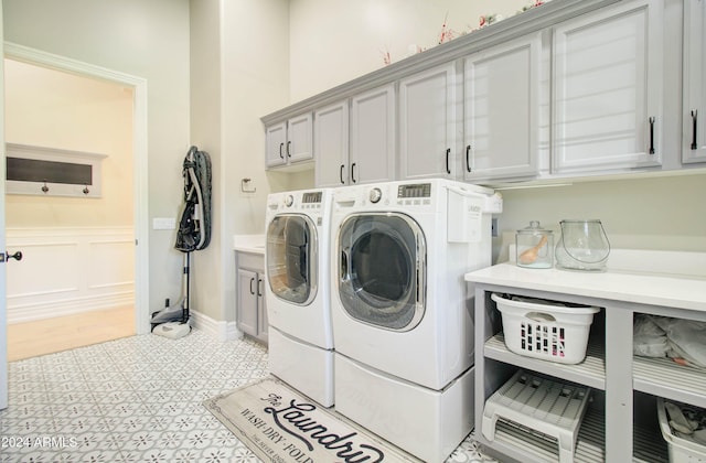 washroom with cabinets and independent washer and dryer