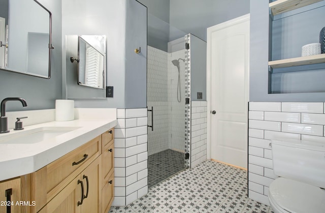 bathroom featuring tile walls, an enclosed shower, vanity, and toilet