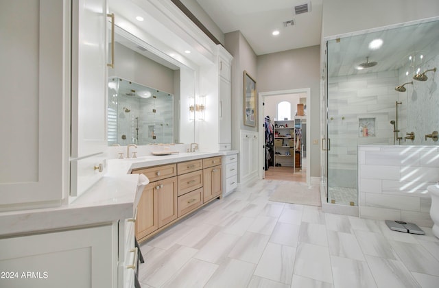 bathroom with tile patterned flooring, an enclosed shower, and vanity