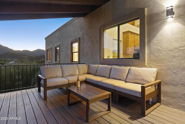 wooden deck with a mountain view and an outdoor living space