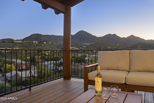 deck featuring outdoor lounge area and a mountain view