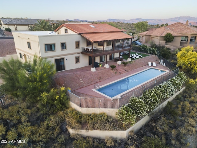 view of swimming pool with a fenced backyard, a mountain view, a fenced in pool, and a patio