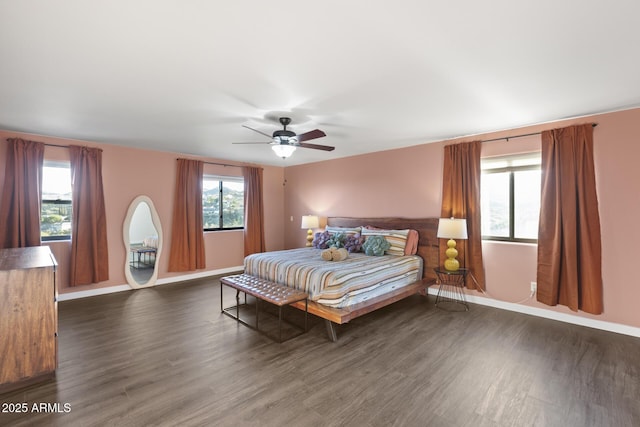 bedroom featuring dark wood-style floors, ceiling fan, and baseboards