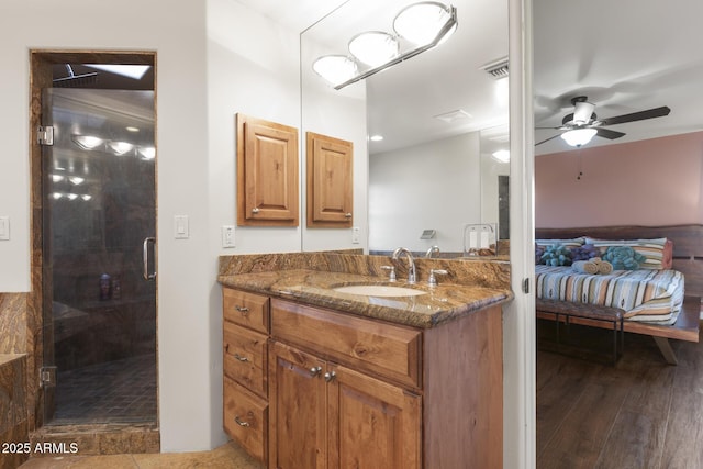 full bathroom featuring visible vents, a ceiling fan, connected bathroom, vanity, and a shower stall