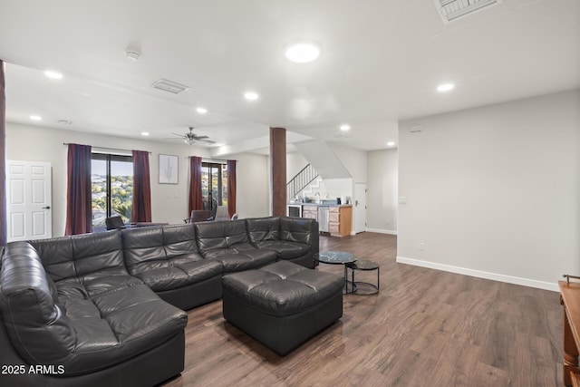 living area with stairs, dark wood finished floors, visible vents, and recessed lighting