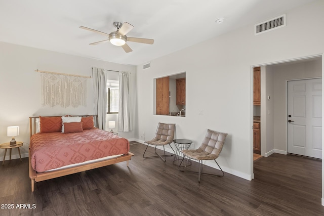 bedroom with dark wood-style flooring, visible vents, and baseboards