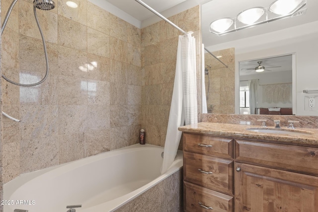 bathroom with tiled shower / bath combo and vanity