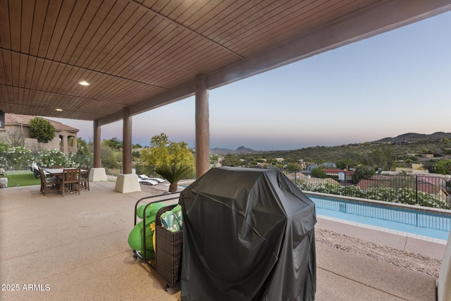 view of patio / terrace featuring outdoor dining area, grilling area, fence, and a fenced in pool