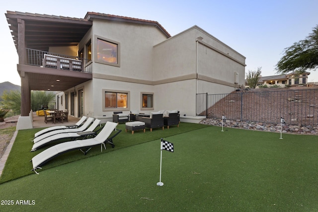 back of house with a patio, a balcony, fence, an outdoor living space, and stucco siding