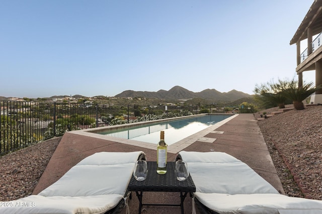 view of pool with fence, a mountain view, and a fenced in pool