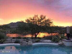 view of pool at dusk