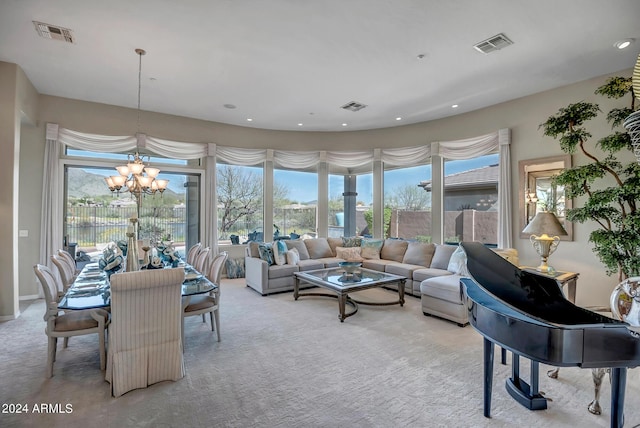 carpeted living room featuring an inviting chandelier and a wealth of natural light