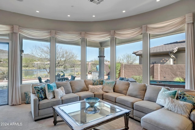 sunroom / solarium featuring plenty of natural light and a water view