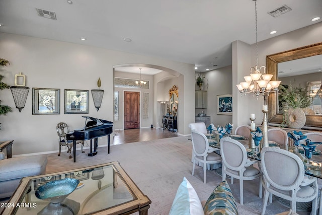 carpeted dining area featuring an inviting chandelier