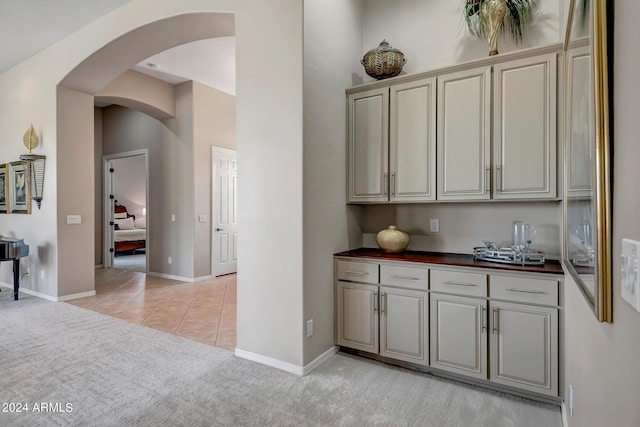 kitchen with butcher block counters and light tile patterned floors